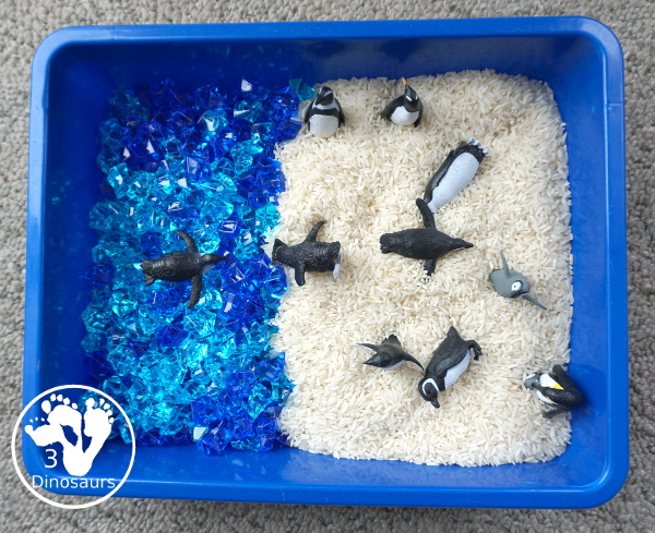 Penguin Rice Sensory Bin - with penguins, blue acrylic rocks and rice for a fun polar animal sensory bin that kids can play in. - 3Dinosaurs.com