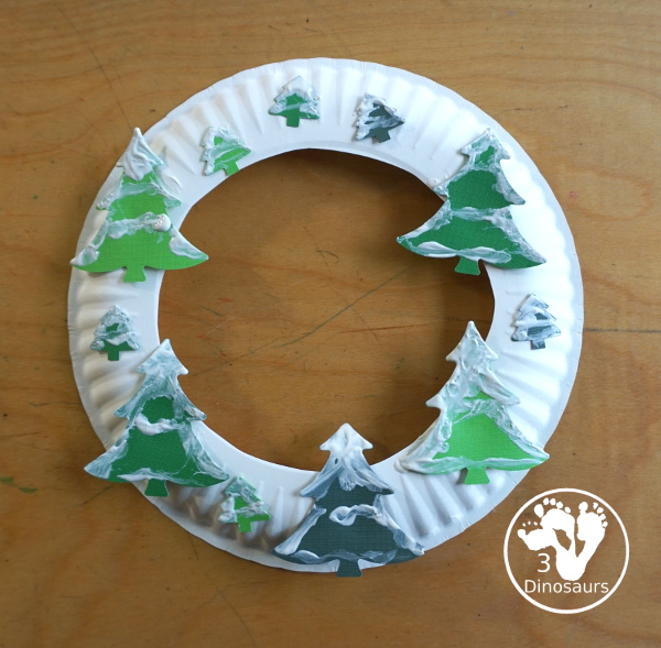 Winter Evergreen Tree Wreath Craft - a fun winter theme wreath with evergreen trees with white q-tip painting a fun craft for prek and kindergarten - 3Dinosaurs.com