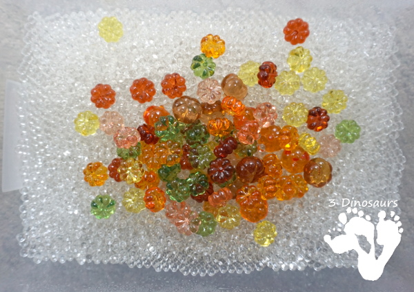 Pumpkin Water Beads Sensory Bin - fun sensory play with clear water beads and acrylic pumpkins make a fun sensory play for the fall - 3Dinosaurs.com