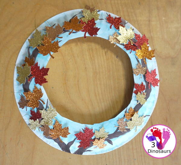 Fall Leaf Wreath Craft for Kids with a watercolor painted paper plate and leaves made from glitter paper - 3Dinosaurs.com
