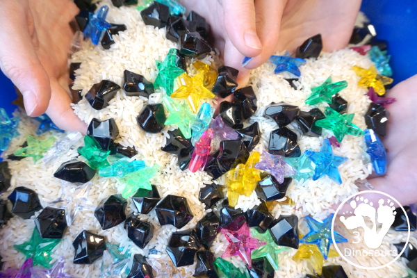 Star Sensory Bin For a Space Theme for kids in preschool, prek and kindergarten. A fun and easy to set up sensory bin with stars, black rocks and rice for base for a space theme - 3Dinosaurs.com