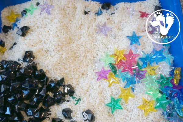 Star Sensory Bin For a Space Theme for kids in preschool, prek and kindergarten. A fun and easy to set up sensory bin with stars, black rocks and rice for base for a space theme - 3Dinosaurs.com