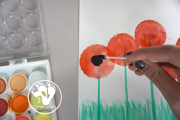 Watercolor Poppy Painting For Veteran's Day - a fun  watercolor painting using cookie cutters for the circle flowers and q-tip painting for the center. Simple and easy to do with kids. - 3Dinosaurs.com
