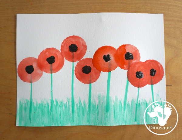 Watercolor Poppy Painting For Veteran's Day - a fun watercolor painting using cookie cutters for the circle flowers and q-tip painting for the center. Simple and easy to do with kids. - 3Dinosaurs.com