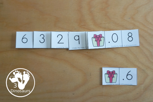 Free Christmas Themed Place Value Arrow Cards - work on building numbers from 0 to 9999 or 9999.99 to 0.99 with these Christmas Themed arrow cards. Plus use task cards to build the numbers. - 3Dinosaurs.com