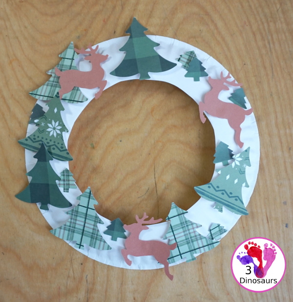 Reindeer Christmas Wreath Craft - a super easy wreath made with reindeer punches and tree punches that kids can make - 3Dinosaurs.com
