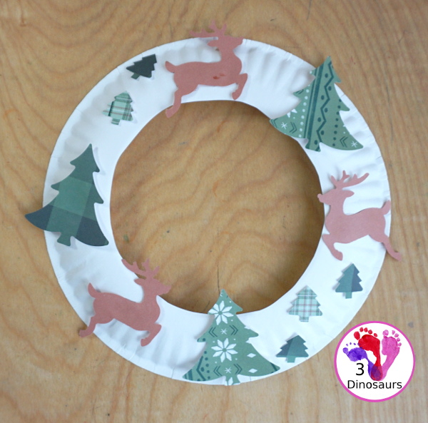 Reindeer Christmas Wreath Craft - a super easy wreath made with reindeer punches and tree punches that kids can make - 3Dinosaurs.com