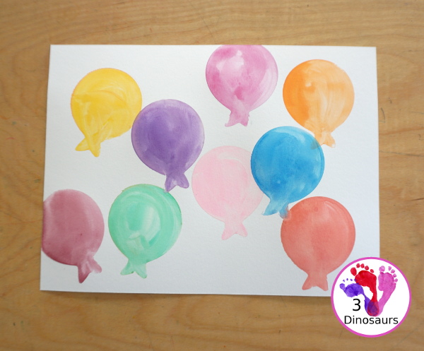 Balloon Watercolor Painting with Cookie Cutters - a simple watercolor painting with a balloon cookie cutter that kids of all ages can do for a party or New Year's Eve - 3Dinosaurs.com