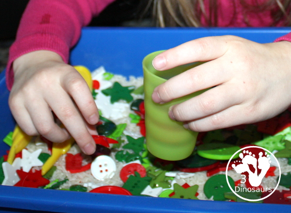 Christmas Button Sensory Bin is a simple and easy button sensory bin with a rice base that uses the colors red, green, and white. 3Dinosaurs.com