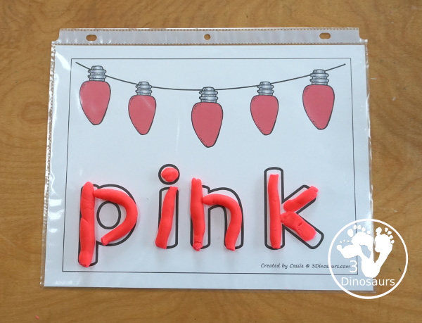 Free Christmas Color Word Playdough Mat Printables - a strip of Christmas lights in a single color with color word below. A fun Christmas theme for color word playdough mat for kids.- 3Dinosaurs.com