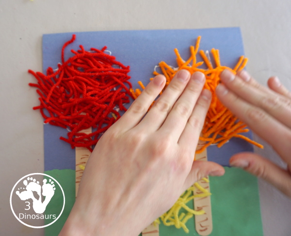 Yarn Truffula Trees - a fun and easy craft for the book The Lorax and Earth Day. You use paper, craft sticks and yarn to make the truffula trees.  3Dinosaurs.com