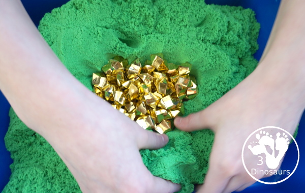 St. Patrick's Day Gold Find Sensory Bin - a fun kinetic sand sensory bin for St. Patrick's Day with finding the gold in the sensory bin - 3Dinosaurs.com