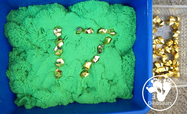 St. Patrick's Day Gold Find Sensory Bin - a fun kinetic sand sensory bin for St. Patrick's Day with finding the gold in the sensory bin - 3Dinosaurs.com