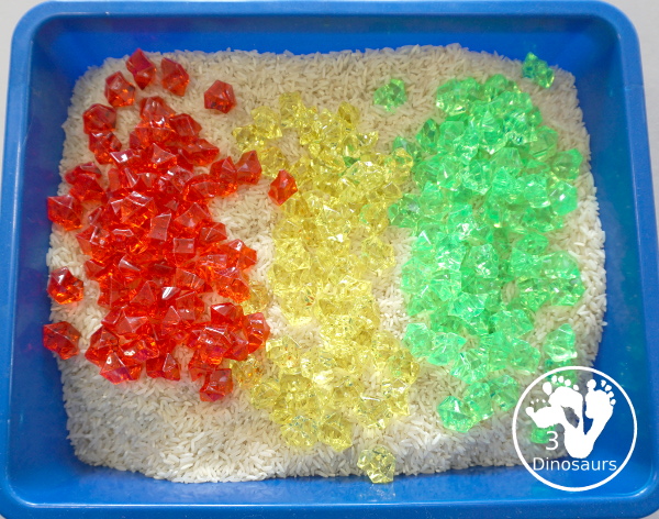 Red, Green and Yellow Sensory Bin - a simple rice and acrylic rock sensory bin with the colors of apples red, green and yellow. A simple time to setup and use. - 3Dinosaurs.com