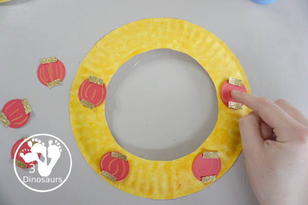 Lunar New Year Wreath Craft for kids - a simple paper plate wreath you can make with kids for the lunar new year and Chinese New year with a red lantern theme  - 3Dinosaurs.com