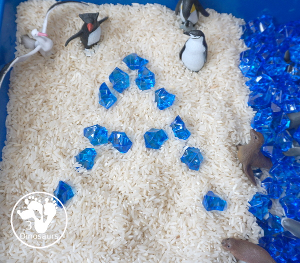 Antarctic Sensory Bin - a simple Antarctic sensory bin with animals, rice and acrylic blue rocks. Easy to set up and play time for kids - 3Dinosaurs.com