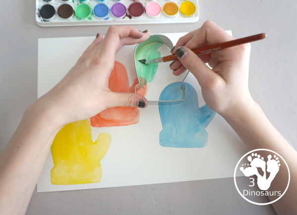 Mitten Watercolor Painting With Cookie Cutters - A simple painting you can do with kids of different ages by painting inside a cookie cutter to make a fun mitten painting - 3Dinosaurs.com