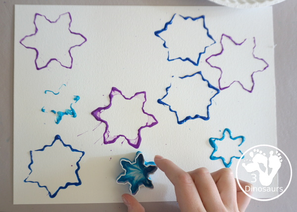 Colored Snowflake Cookie Cutter Stamping - A simple stamp painting with cookie cutters. You have several sizes and different colors of blues and purple - 3Dinosaurs.com