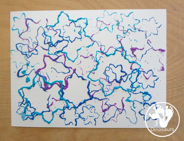 Colored Snowflake Cookie Cutter Stamping - A simple stamp painting with cookie cutters. You have several sizes and different colors of blues and purple - 3Dinosaurs.com