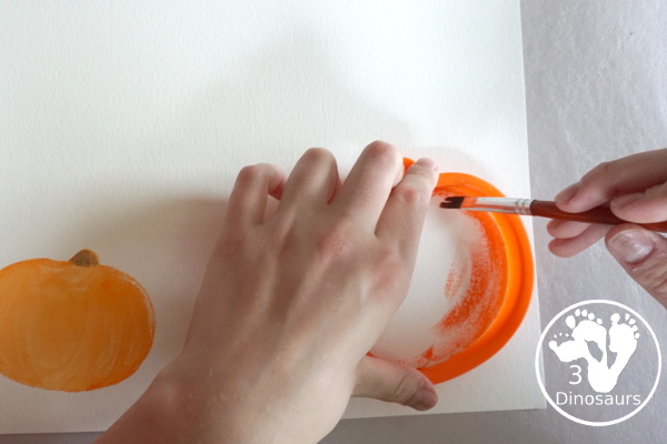 Pumpkin Cookie Cutter Watercolor Painting - a fun watercolor painting activity with pumpkin cookie cutters to make the pumpkins. Simple pumpkin paintings that different ages can do. - 3Dinosaurs.com