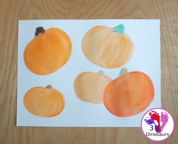 Pumpkin Cookie Cutter Watercolor Painting - a fun watercolor painting activity with pumpkin cookie cutters to make the pumpkins. Simple pumpkin paintings that different ages can do. - 3Dinosaurs.com