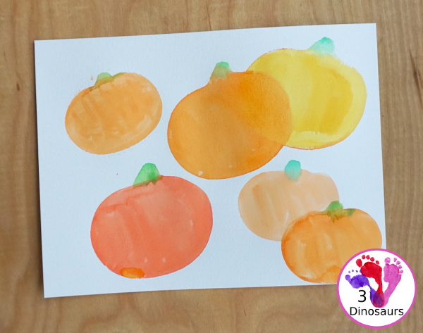 Pumpkin Cookie Cutter Watercolor Painting - a fun watercolor painting activity with pumpkin cookie cutters to make the pumpkins. Simple pumpkin paintings that different ages can do. - 3Dinosaurs.com