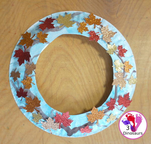 Fall Leaf Wreath Craft for Kids with a watercolor painted paper plate and leaves made from glitter paper - 3Dinosaurs.com