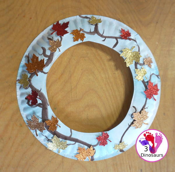 Fall Leaf Wreath Craft for Kids with a watercolor painted paper plate and leaves made from glitter paper - 3Dinosaurs.com