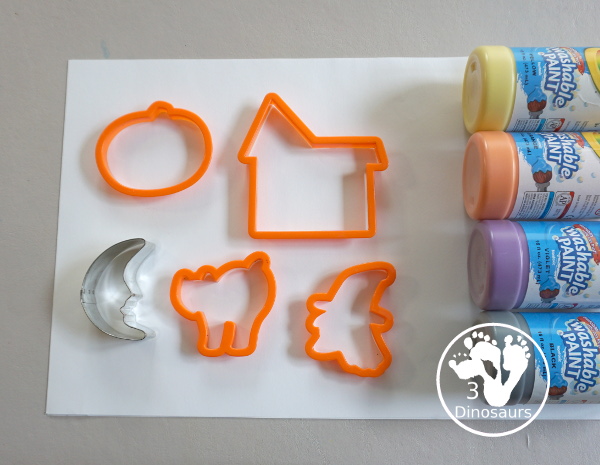 Halloween Stamping With Cookie Cutters - painting with cookie cutters using them to stamp paint with the cookie cutters on a piece of paper. A great tot, preschool and prek painting activity - 3Dinosaurs.com