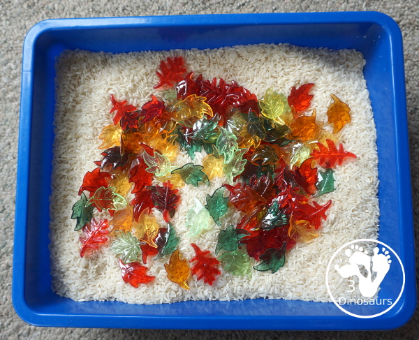 Fall Leaves Sensory Bin - a simple fall leaf sensory bin with different colors of leaves with red, yellow, orange, and green leaves. The sensory bin as a rice filler. - 3Dinosaurs.com