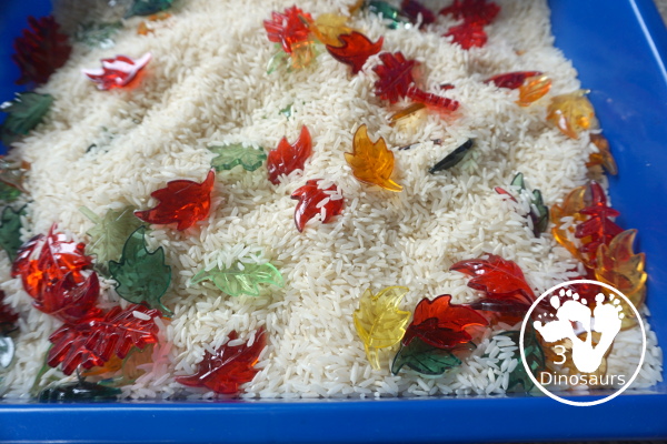 Fall Leaves Sensory Bin - a simple fall leaf sensory bin with different colors of leaves with red, yellow, orange, and green leaves. The sensory bin as a rice filler. - 3Dinosaurs.com