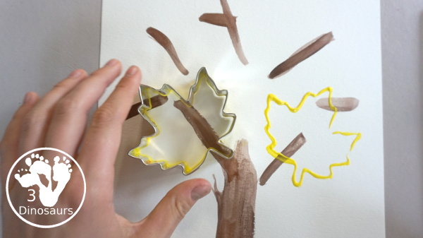 Fall Tree Painting with Leaf Cookie Cutters - keep stamping leaves on the paper - 3Dinosaurs.com