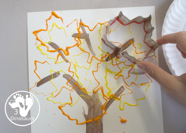 Fall Tree Painting with Leaf Cookie Cutters - keep stamping leaves on the paper - 3Dinosaurs.com