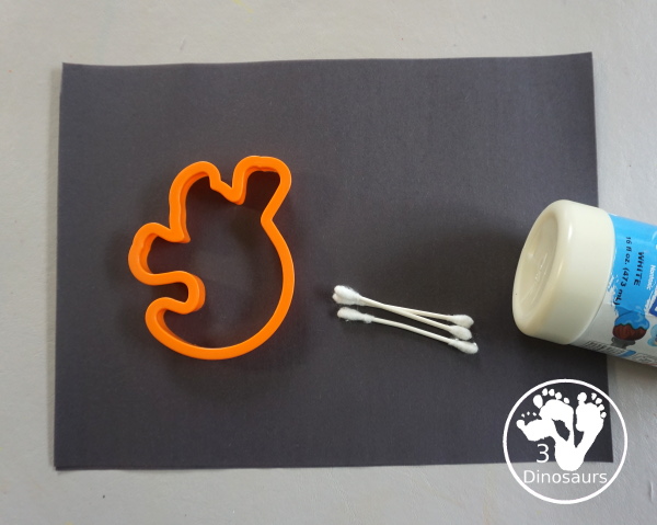 Ghost Painting with Cookie Cutters - a super simple painting inside ghost cookie cutters with white paint and black paper - 3Dinosaurs.com