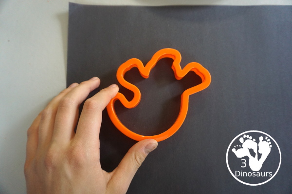 Ghost Painting with Cookie Cutters - a super simple painting inside ghost cookie cutters with white paint and black paper - 3Dinosaurs.com