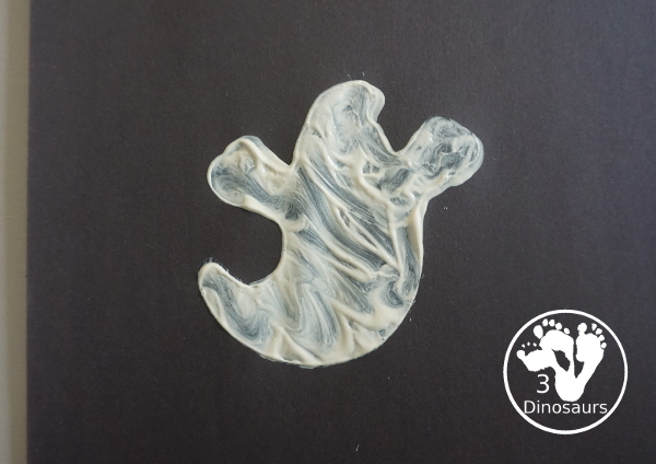 Ghost Painting with Cookie Cutters - a super simple painting inside ghost cookie cutters with white paint and black paper - 3Dinosaurs.com