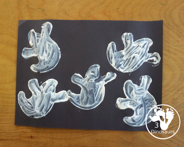 Ghost Painting with Cookie Cutters - a super simple painting inside ghost cookie cutters with white paint and black paper - 3Dinosaurs.com