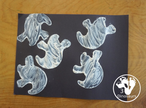 Ghost Painting with Cookie Cutters - a super simple painting inside ghost cookie cutters with white paint and black paper - 3Dinosaurs.com