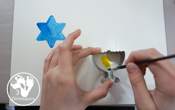 Hanukkah Watercolor Cookie Cutter Painting - a simple watercolor painting for Hanukkah using Hanukkah themed cookie cutters - 3Dinosaurs.com