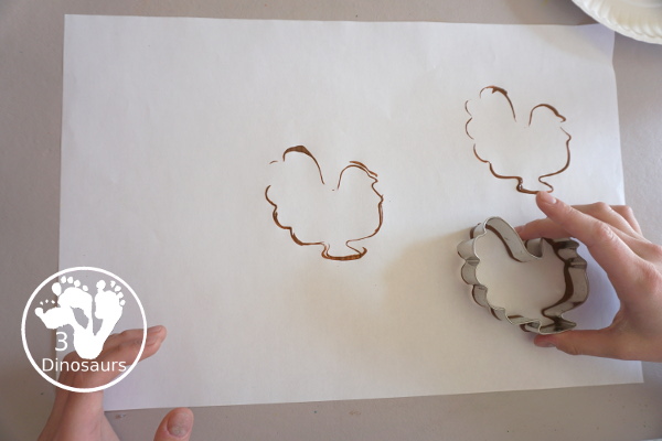 Thanksgiving Cookie Cutter Stamp Painting - with turkey, leaf and pumpkin stamp painting. This is a fun art that different ages can do together. A great process art that can be used as a placemat as well. - 3Dinosaurs.com