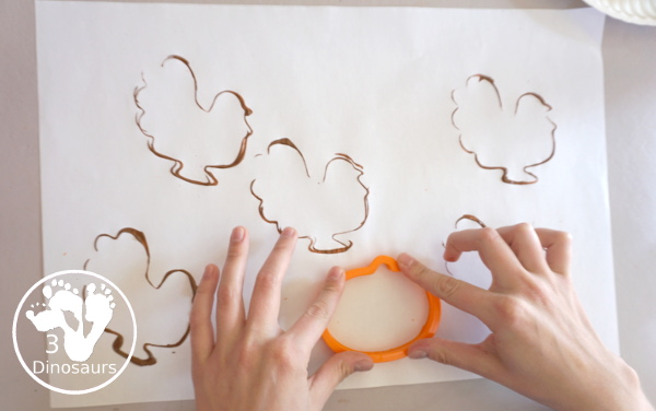 Thanksgiving Cookie Cutter Stamp Painting - with turkey, leaf and pumpkin stamp painting. This is a fun art that different ages can do together. A great process art that can be used as a placemat as well. - 3Dinosaurs.com