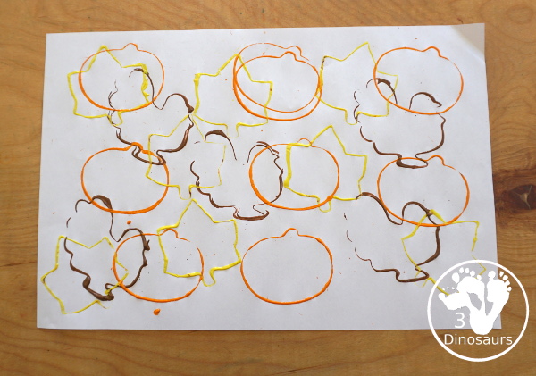 Thanksgiving Cookie Cutter Stamp Painting - with turkey, leaf and pumpkin stamp painting. This is a fun art that different ages can do together. A great process art that can be used as a placemat as well. - 3Dinosaurs.com