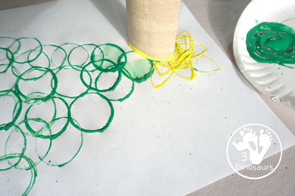 Christmas Tree Paper Roll Painting - a fun painting craft that you can do with kids to make a Christmas tree - 3Dinosaurs.com