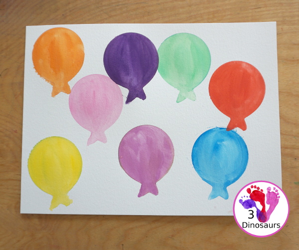 Balloon Watercolor Painting with Cookie Cutters - a simple watercolor painting with a balloon cookie cutter that kids of all ages can do for a party or New Year's Eve - 3Dinosaurs.com