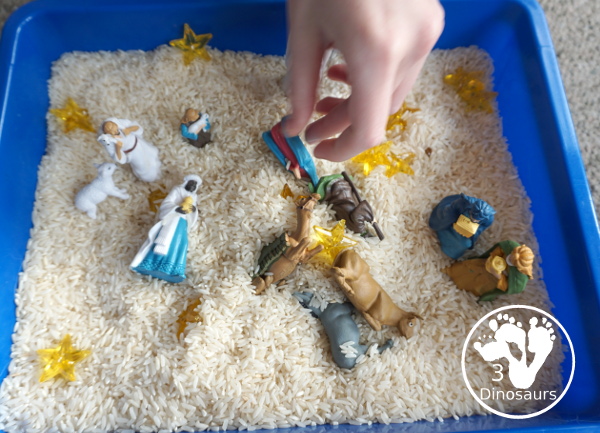 Nativity Sensory Bin For Christmas - a simple sensory bin to explore parts of the nativity with kids. You have nativity figures, rice and stars in this Christmas sensory bin. - 3Dinosaurs.com