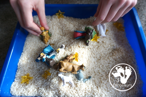 Nativity Sensory Bin For Christmas - a simple sensory bin to explore parts of the nativity with kids. You have nativity figures, rice and stars in this Christmas sensory bin. - 3Dinosaurs.com