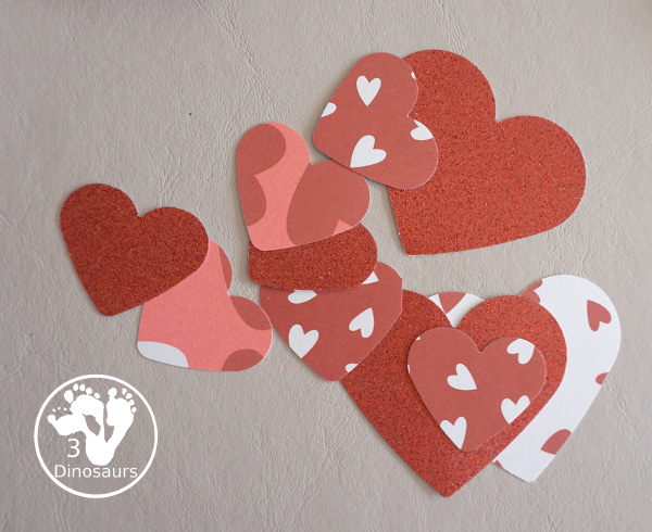 Valentines Heart Wreaths with Scrapbook Paper a fun paper plate wreath made using a heart punch and loads of fun for Valentines Day - 3Dinosaurs.com