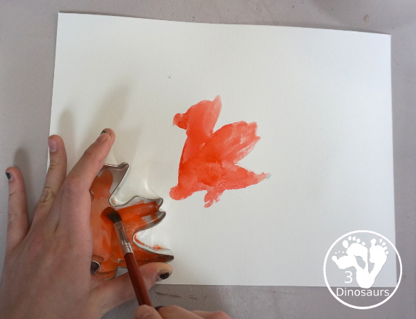 Dragon Watercolor Painting with rainbow color dragons made with a dragon cookie cutter and watercolor paints. A simple painting activity for different ages- 3Dinosaurs.com