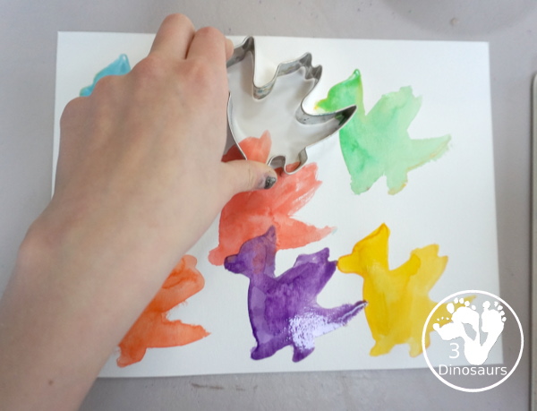 Dragon Watercolor Painting with rainbow color dragons made with a dragon cookie cutter and watercolor paints. A simple painting activity for different ages- 3Dinosaurs.com