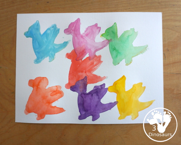 Dragon Watercolor Painting with rainbow color dragons made with a dragon cookie cutter and watercolor paints. A simple painting activity for different ages- 3Dinosaurs.com